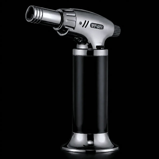 Butane torch with black and silver design on a black background